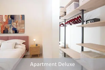 a bedroom with a bed and a room with a shelf at Best Vatican Apartment in Rome