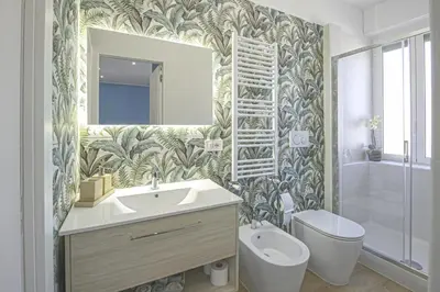 a bathroom with a sink and a toilet and a mirror at Casetta Tuscolana in Rome