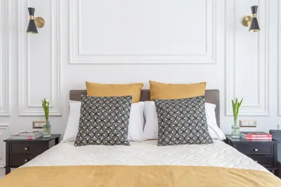a bedroom with a bed with two night stands at Rhome Vatican Rooms in Rome