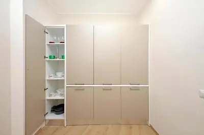 a closet with white cabinets in a room at 4BNB - Ottaviano Vatican Flat in Rome