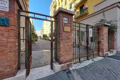 an entrance to a brick building with a iron gate at Etruria At San Giovanni by Halldis in Rome