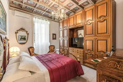 a bedroom with a bed and a tv in it at Villa Alberici in Rome
