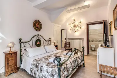a bedroom with a bed with two towels on it at Villa Alberici in Rome