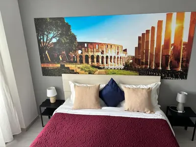 a bedroom with a large white bed with red pillows at Domus Viatoris in Rome