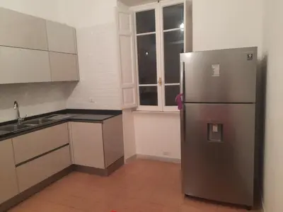 a kitchen with a stainless steel refrigerator and a window at Delizioso appartamento al Pigneto in Rome