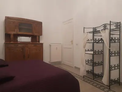 a bedroom with a bed and a dresser and a television at Delizioso appartamento al Pigneto in Rome