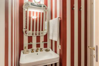 a bathroom with a sink and a mirror at Residenza Brama - Art ApartHotel in Rome