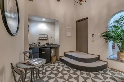 a waiting room with a sink and a table and chairs at Residenza Brama - Art ApartHotel in Rome