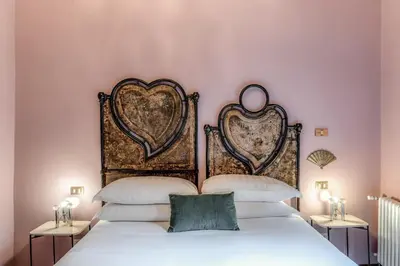 a bedroom with two beds with hearts on the wall at Residenza Brama - Art ApartHotel in Rome