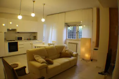 a living room with a couch and a kitchen at Conny's Home in Rome