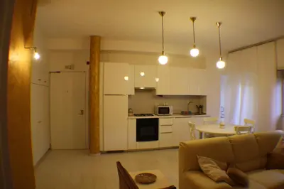 a kitchen and living room with a couch and a table at Conny's Home in Rome