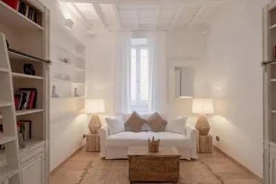 a living room with a white couch and two lamps at Spanish Steps-Trevi -Luma Suite in Rome