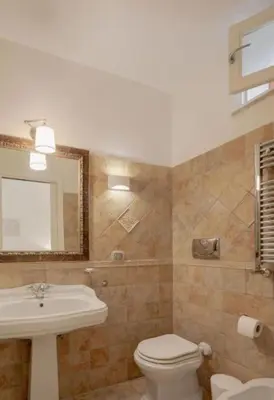 a bathroom with a white toilet and a sink at Spanish Steps-Trevi -Luma Suite in Rome