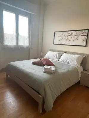 a large bed in a bedroom with two windows at Mon-Tis Paolo V - vicino metro Cornelia in Rome