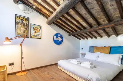 a bedroom with a large bed in a room at Mou Trastevere House by Rental in Rome in Rome