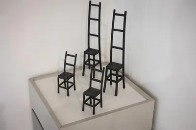 four black chairs sitting on a white shelf at Mou Trastevere House by Rental in Rome in Rome