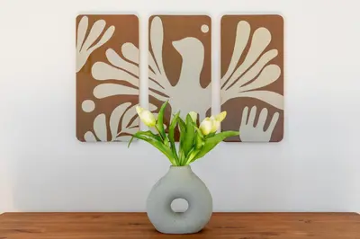 a vase with yellow flowers in it on a table at iFlat Cozy flat with a view in San Giovanni in Rome