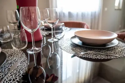 a table with wine glasses and a bowl on it at INTERNO 39 - San Pietro in Rome
