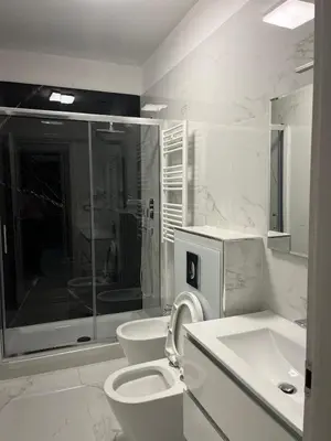 a white bathroom with a toilet and a sink at Vatican Museum Scipioni BED & Breakfast in Rome