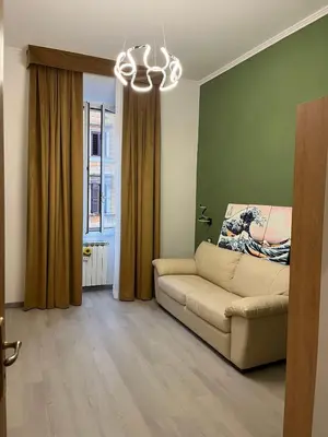 a living room with a couch and a window at Vatican Museum Scipioni BED & Breakfast in Rome