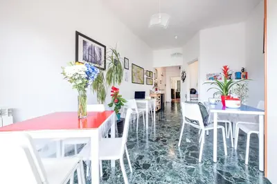 a dining room with white tables and white chairs at Take It Easy Roma Guest House in Rome