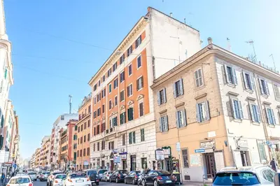 a busy city street with cars parked in front of buildings at Apartment Vatican Walls in Rome