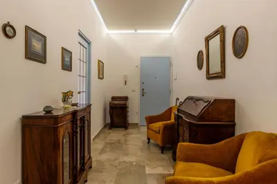 a living room with two chairs and a piano at GuestHost - 4 Winds Holiday Rental in Rome