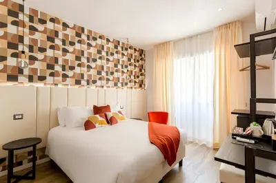 a hotel room with a bed and a desk at Romi Suite in Rome