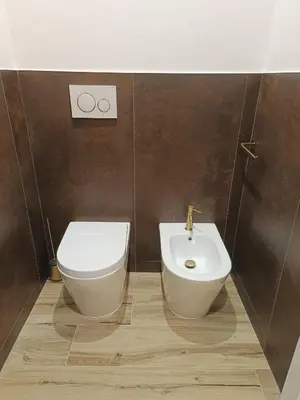 a bathroom with a toilet and a bidet at Romi Suite in Rome