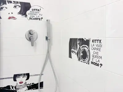 a bathroom with posters on the wall and a phone at Appartamento per 4 persone a Garbatella - My Garba in Rome