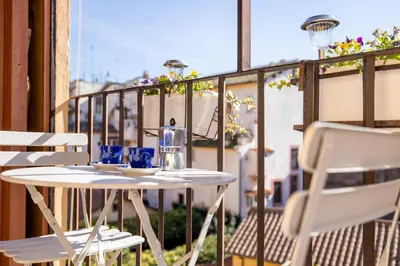 a white table and chairs on a balcony at Maison Blu - in Trastevere in Rome
