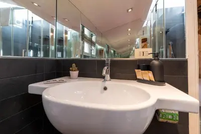 a bathroom with a sink and a tub and a mirror at [15 min from Piazza Venezia] Skyline Sanctuary in Trastevere in Rome