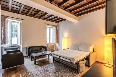 a bedroom with a bed and a couch and a chair at Domus Mondrian Luxury House in Rome