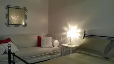 a bedroom with a couch and a table with a lamp at Boezio43B&B in Rome