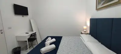 a bedroom with a bed with towels on it at Stazione Telese 41 in Rome