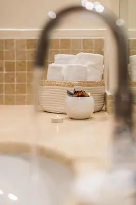 a bathroom with a sink and a bath tub with towels at Diana - Romantic Suite in Rome