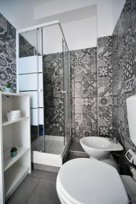 a bathroom with a shower and a toilet and a sink at QUEEN VATICAN in Rome