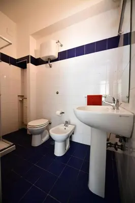 a bathroom with a sink and a toilet at QUEEN VATICAN in Rome