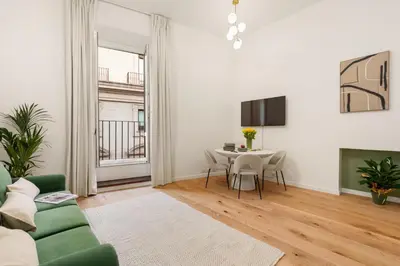 a living room with a green couch and a table at At Twenty-nine - NUOVO e incantevole appartamento! in Rome