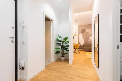 a hallway with white walls and wood floors at Ascanio's Cozy Apartment - by 101Flats in Rome
