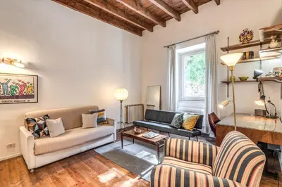 a living room with a couch and a table at Trastevere Design & Comfort in Rome