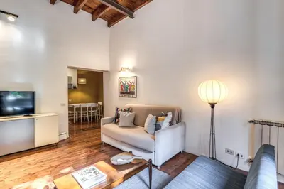 a living room with a couch and a television at Trastevere Design & Comfort in Rome