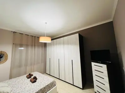 a bedroom with a bed with a teddy bear on it at Apartment Albona 77 in Rome
