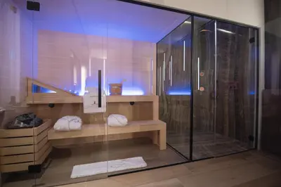 a bathroom with a shower and a glass shower stall at Tritone Luxury Suites Fontana di Trevi in Rome