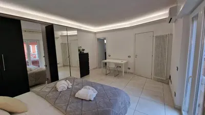 a bedroom with a bed and a desk and a mirror at LG colosseum Rome apartment in Rome