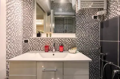 a bathroom with a sink and a mirror at Minerva Apartment in Rome
