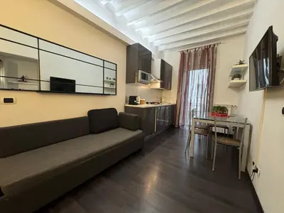 a living room with a couch and a table at Minerva Apartment in Rome