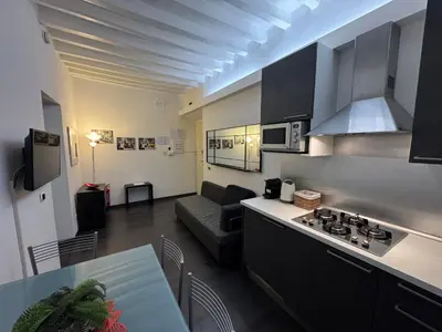 a kitchen with a couch and a table in a room at Minerva Apartment in Rome