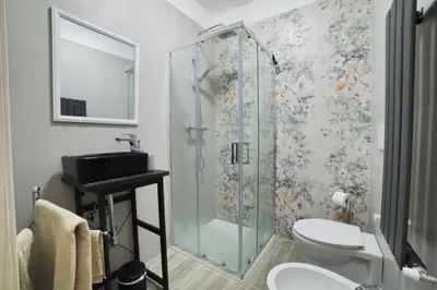 a bathroom with a shower with a toilet and a sink at P88 guesthouse in Rome