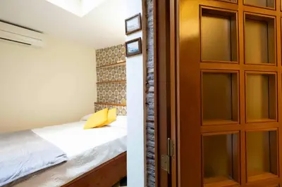 a bedroom with a bed and a wooden door at Le Petit Prince in Rome